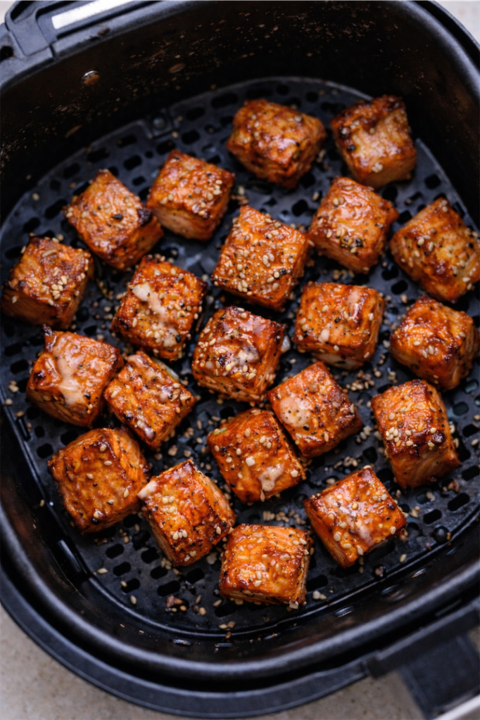 salmon cubes in an airfryer basket cooked