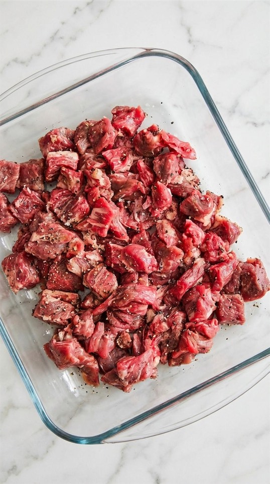 beef marinated in a glass bowl